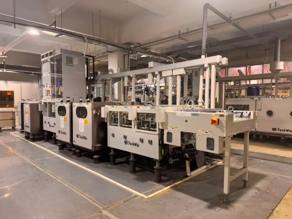 Automated TechWin PCB surface finishing line in a modern facility, optimizing circuit board chemical processing.
