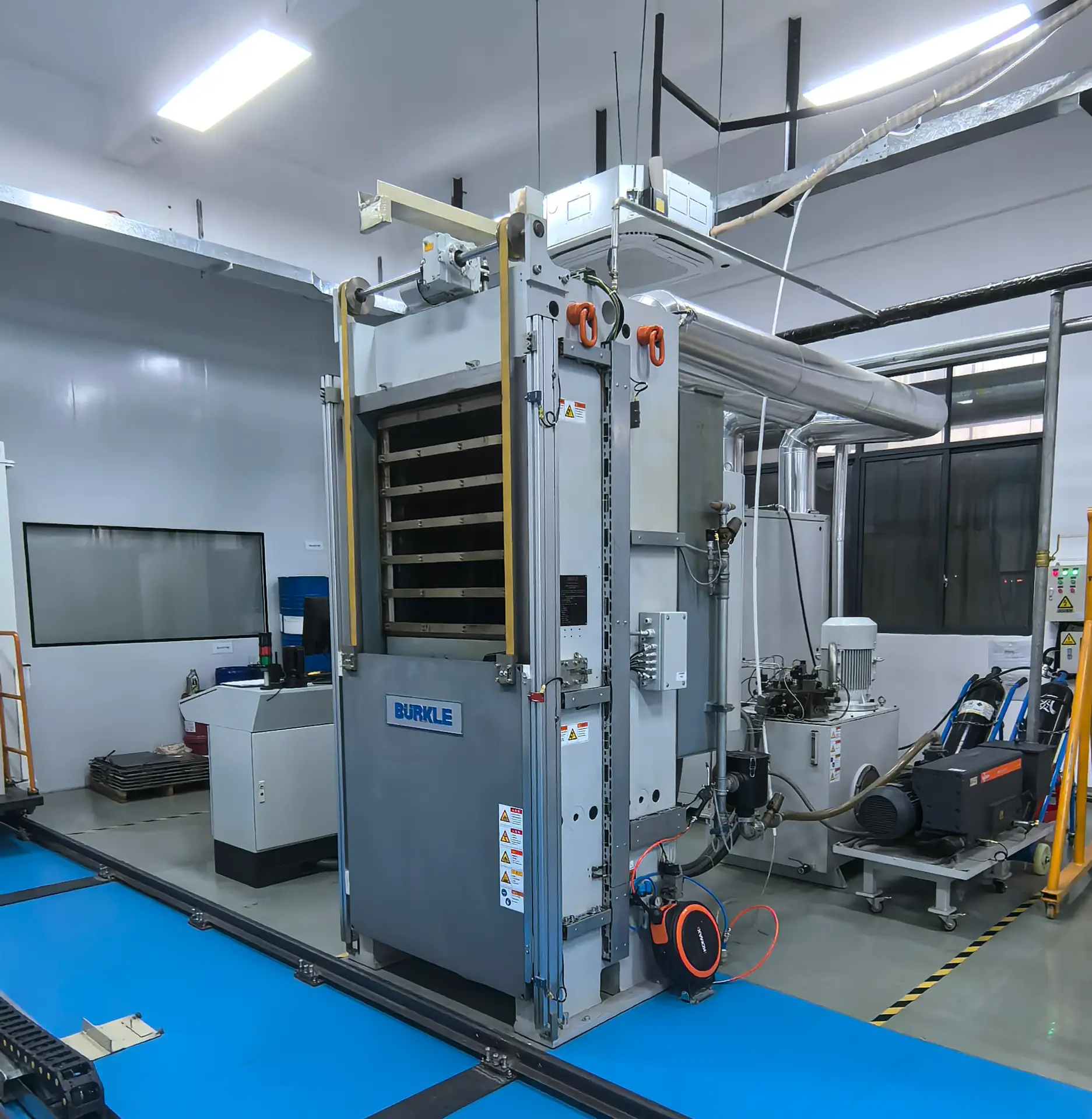 Large Burkle lamination press machine in a clean room, used for high-pressure multi-layer PCB fabrication and circuit board production.