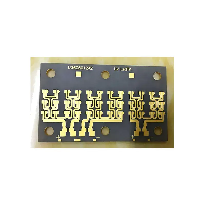 High power UV LED PCB array with gold-plated pads for multiple UV LED chips, featuring connection traces on a dark substrate.