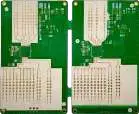 Two green bare printed circuit board (PCB) panels with white silkscreen markings, ready for electronic component assembly.